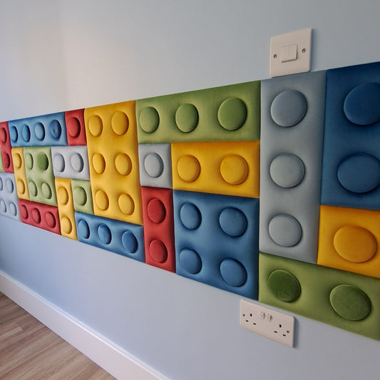 Colourful brick upholstered wall panels on a wall with a wooden floor.