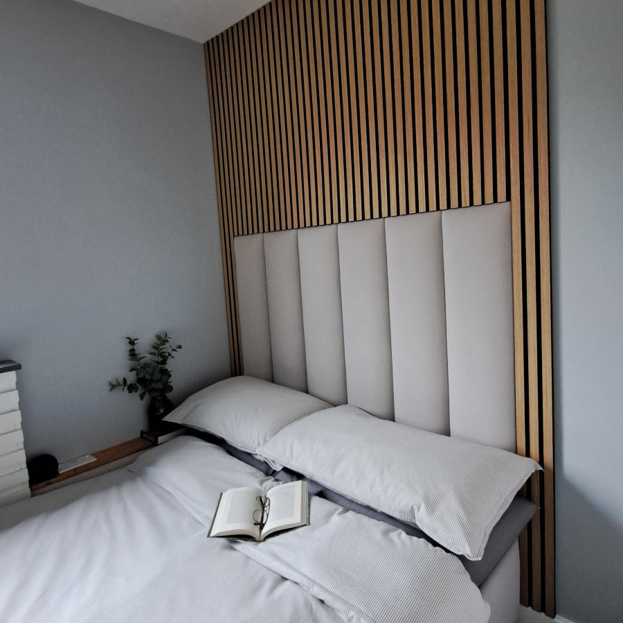 Bedroom with a bed featuring grey bedding and a grey upholstered headboard