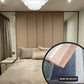 Modern bedroom with a bed and decorative pillows, featuring a close-up of a textured fabric swatch.