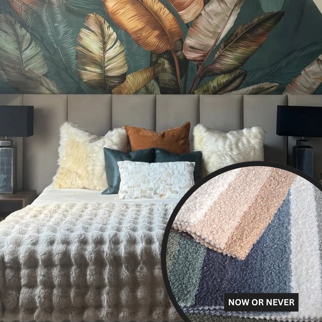 Bedroom with textured bedding and decorative pillows, featuring a close-up of a fabric with 'NOW OR NEVER' text.