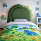 Children's bedroom with dinosaur-themed upholstered headboard and bedding