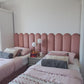 Pink Wall Panels in a room with a bed and nightstand