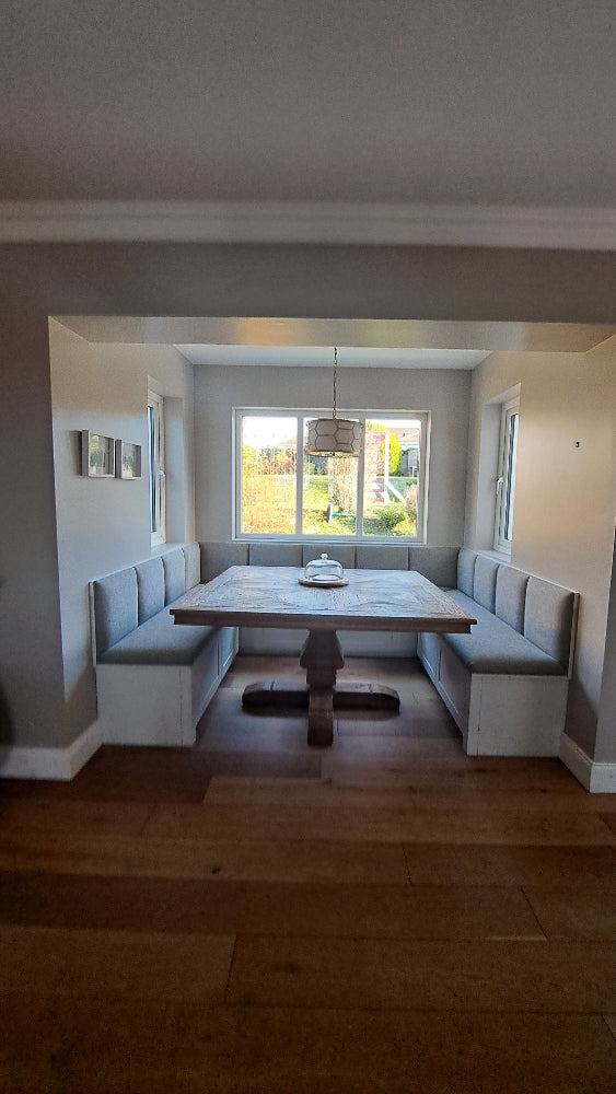 Modern living room with a sofa, coffee table, and large window.
