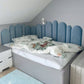 Blue round fence panels as in child's bedroom, varying in height and sizes 