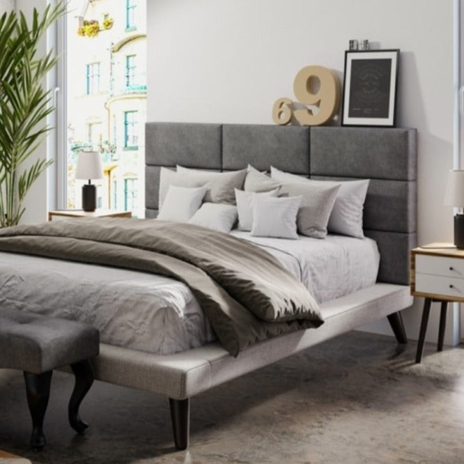 Grey double upholstered wall paneling in bedroom