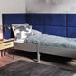 Blue double upholstered wall paneling in bedroom